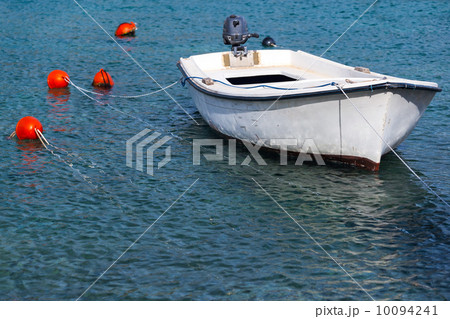 Wooden fishing boat floats moored in Adriatic sea water