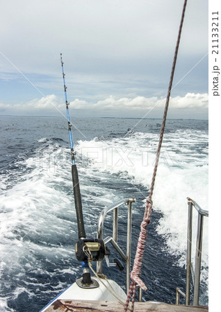 Commercial fishing rods over turquoise water. Fishing equipment on