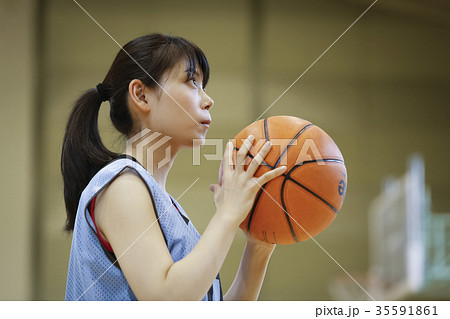 女性 バスケットボール シュート 狙うの写真素材