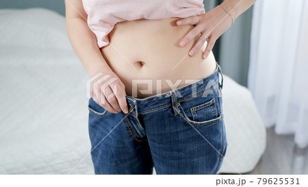 Close up view of stomach. Beautiful woman with slim body in