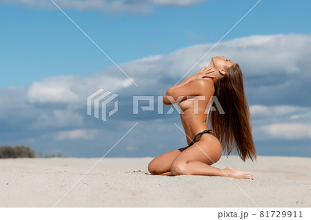 Naked women in panties hugging on beach - Stock Photo [84277115