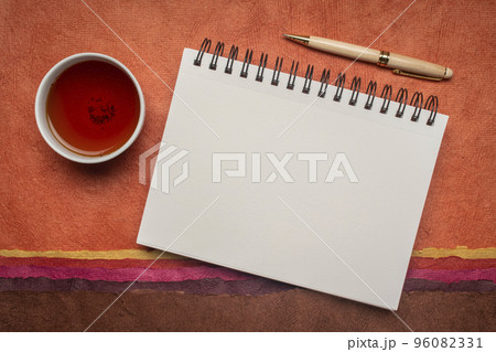 Blank Spiral Sketchbook with White Pages Against Colorful Abstract