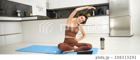 Active lifestyle and health. Happy young woman does workout, sits